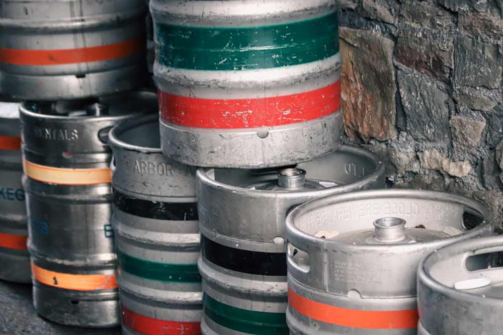 Chemical drums stacked up against a wall